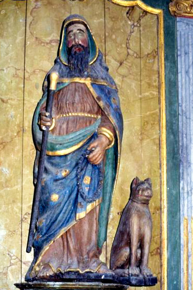 Statue aus dem 16. Jhd. des Saint Hervé mit Hund. Interieur der Pfarrkirche Saint-Hervé in Lanhouarneau (Frankreich).